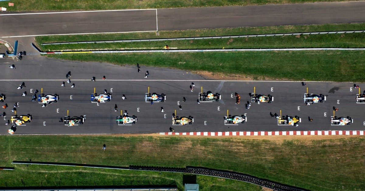 A wide view of the F4 Indian Championship grid assembling on track