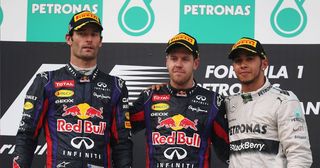 Race winner Sebastian Vettel (C) of Germany and Infiniti Red Bull Racing, second placed Mark Webber (L) of Australia and Infiniti Red Bull Racing and third placed Lewis Hamilton of Great Britain and Mercedes GP react on the podium following the Malaysian Formula One Grand Prix at the Sepang Circuit on March 24, 2013 in Kuala Lumpur, Malaysia. (Photo by Mark Thompson/Getty Images)