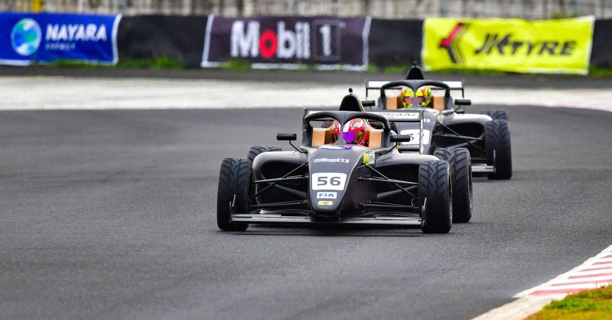 Two F4 Indian Championship cars running close at Kari Motor Speedway
